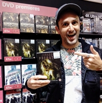 Nathan Head holding a Jurassic Predator DVD in HMV Chester